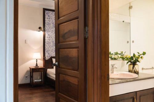 a bathroom with a sink and a mirror at Indochine 4Bedrooms house Heart Old Quarter by SSens Homes in Hanoi