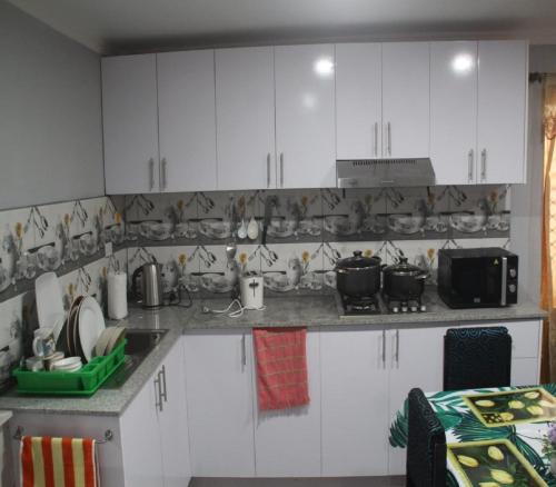 a kitchen with white cabinets and a counter top at Mount Olivet House in Suva