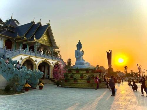 a statue in front of a building with the sunset at Flamingo Hải Tiến - Căn góc 2 Phòng - View 2 mặt biển in Thanh Hóa