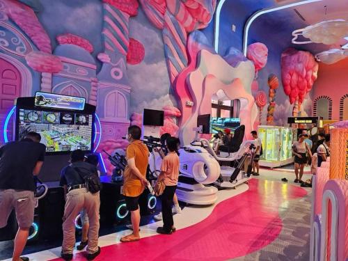 a group of people playing a video game in a room at Flamingo Hải Tiến - Căn góc 2 Phòng - View 2 mặt biển in Thanh Hóa