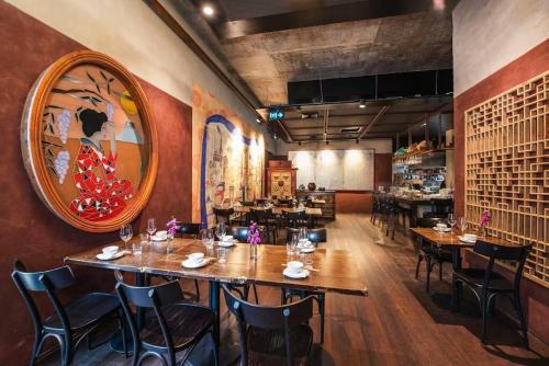 a restaurant with wooden tables and chairs and a large mirror at Studio Apartment Elizabeth Bay Potts Point in Sydney