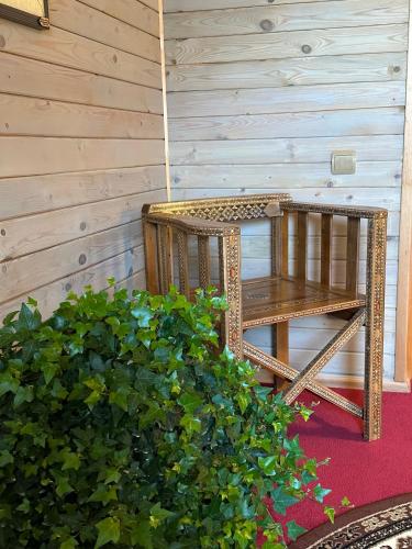 a wooden bench sitting on the porch of a house at Rakši in Cēsis