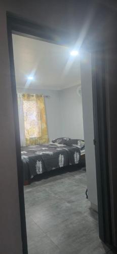 a room with two beds in a room with a mirror at Mount Olivet House in Suva