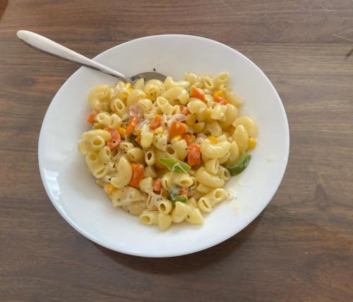 a plate of pasta with vegetables on a table at Wildlife Retreat in Tāla