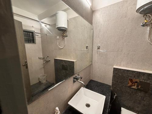 La salle de bains est pourvue d'un lavabo et d'un miroir. dans l'établissement Atulya Green By Meyatri, à Jaipur