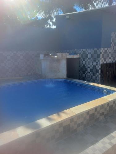uma grande piscina azul numa casa em Pousada Coqueirais em Mongaguá