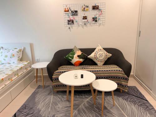 a living room with a couch and two tables at Vinhome Grand Park Homestay-Cozy House in Gò Công