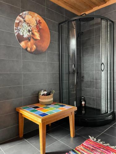 a bathroom with a wooden table and a shower at Rakši in Cēsis