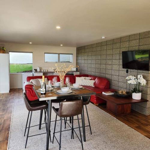 a living room with a table and a red couch at Seascape in Langs Beach