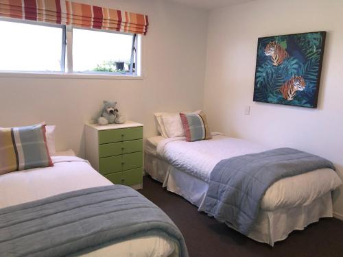 a bedroom with two beds and a window at Seascape in Langs Beach