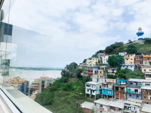 a view from a glass window of a city at Depa de lujo con piscina y jacuzzi in Guayaquil