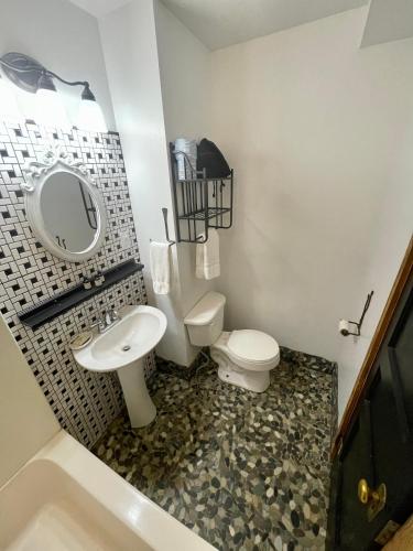 a bathroom with a sink and a toilet and a tub at Skyline Village Inn in Spruce Pine