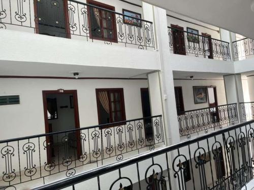 a row of balconies on a building with iron fences at Hotel Davinci Calarca in Calarcá
