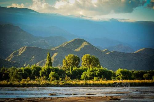 a body of water with mountains in the background at Río de Chocolate in Santa María