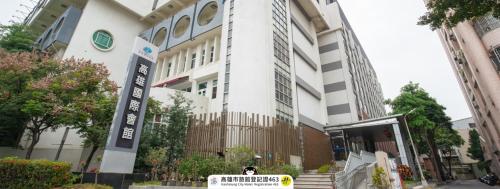 a person is standing in front of a building at Kaohsiung International Plaza in Kaohsiung