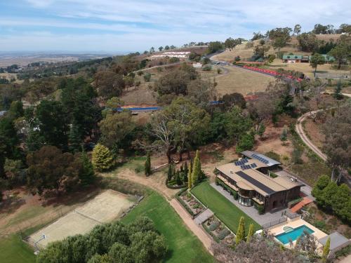 an aerial view of a house with a pool at The Cutting Mount Panorama in Mount Panorama