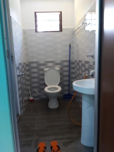a bathroom with a toilet and a sink at Homestay Haji Noor in Tanah Merah
