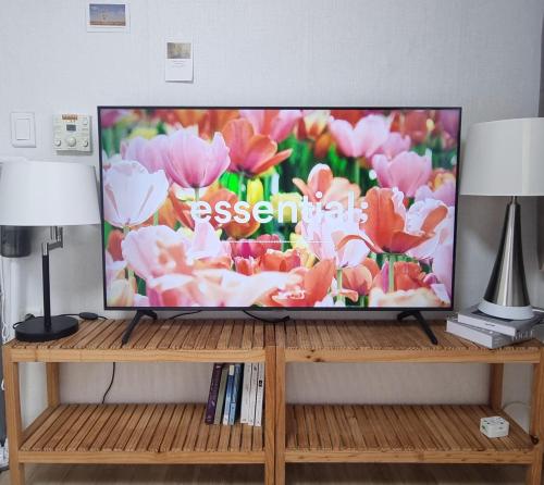 a flat screen tv sitting on top of a wooden stand at Stay Cheongnyang in Seoul