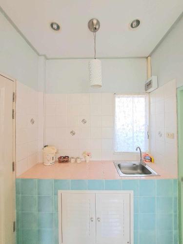 a kitchen with a sink and a counter top at Prathana Garden Beach Resort in Hua Hin