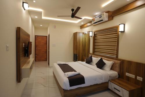 a bedroom with a large bed in a room at Mesteria Inn Wayanad in Wayanad