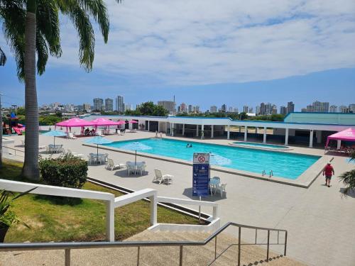 a large swimming pool with a person walking by it at Villa Country Club Salinas in Salinas