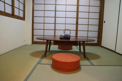 a small table and a stool in a room with a table and a stool at 有朋ハウス302 in Osaka