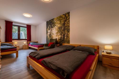 a bedroom with a large bed and a living room at White Hawk - Vila Sokolík in Lazisko