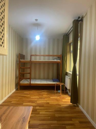 a room with two bunk beds and a wooden floor at Middle River Apartment & Tours in Ulaanbaatar