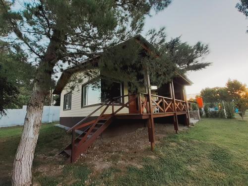 uma pequena casa sentada num quintal ao lado de uma árvore em Chalet Alter Boss em La Cumbre