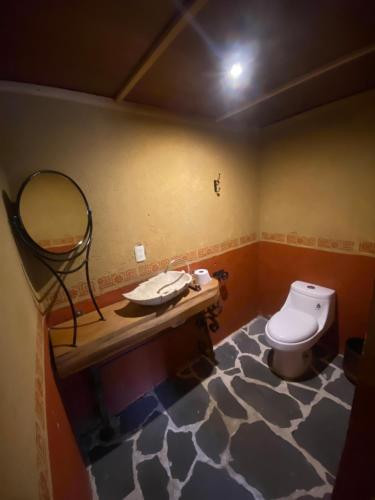uma casa de banho com um lavatório e um WC. em Hotel Temazcal Kinam em Atlautla