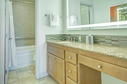 a bathroom with a sink and a shower at Desert Rose Resort in Las Vegas