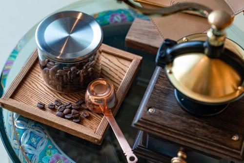 a table with a tray with a cup of coffee and a spoon at Isoaruki no Yuyado Ushiogumo -6 years or older- in Kawazu