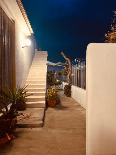 a set of stairs next to a white building with a stair case at Dream Holiday in Marina di Lizzano