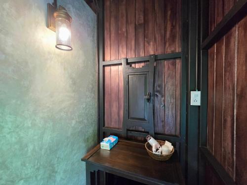 a room with a table with a basket and a door at Baan Koh Kwang Pool Villa Krabi in Krabi town