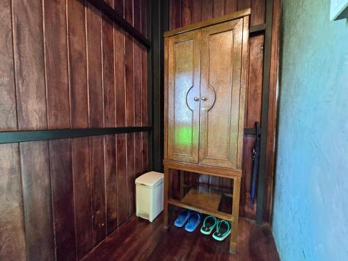 a room with a cabinet with pairs of shoes in it at Baan Koh Kwang Pool Villa Krabi in Krabi town