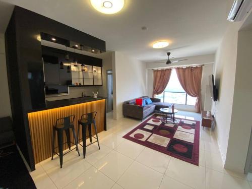 a kitchen and a living room with a bar in a room at Wonderful Home 2 Bedrooms By shkrnshh in Cheras