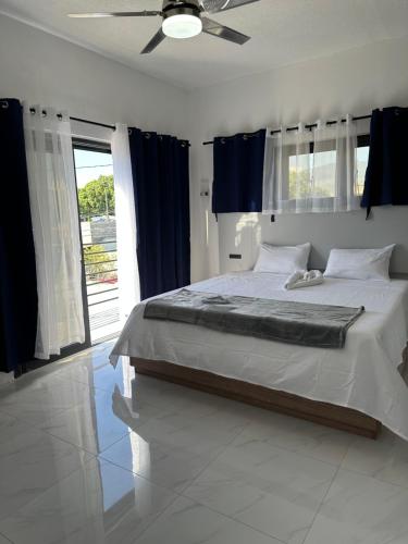 Schlafzimmer mit einem Bett und einem Deckenventilator in der Unterkunft White Signature Suite in Kingston