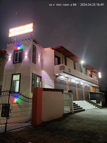 a white building with a sign on it at night at Hotel Krishna in Kumbakonam