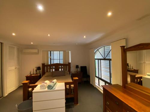 a bedroom with a bed and a table with towels at Everingham Views in Rockhampton