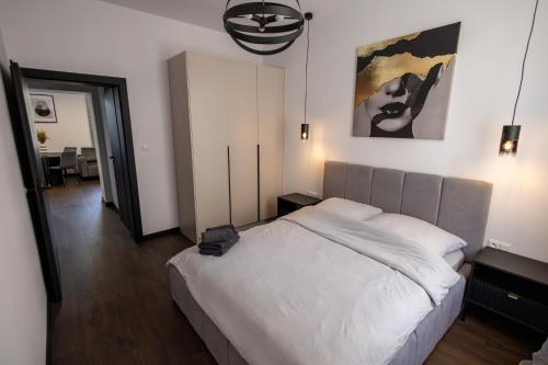a bedroom with a large bed and a mirror at Apartament Prestige in Nowy Sącz