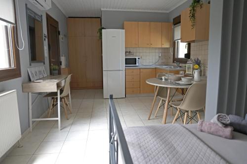 a kitchen with a refrigerator and a table and chairs at ANASTASIA in Mákri