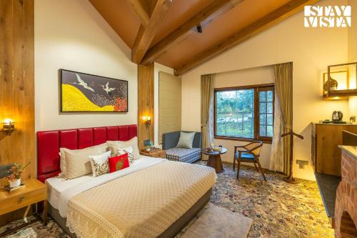 a hotel room with a bed and a chair at StayVista at Swiss Chalet - Tangmarg with Gazebo & Lawn in Tangmarg