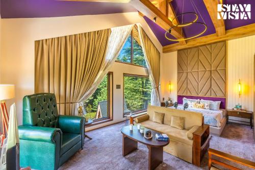 a living room with a couch and a bed at StayVista at Swiss Chalet - Tangmarg with Gazebo & Lawn in Tangmarg