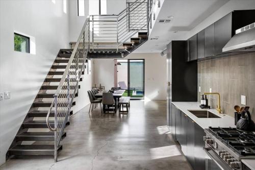 a kitchen and dining room with a spiral staircase at NEW Modern 3BR & Loft- Heated pool, Near airport in Phoenix