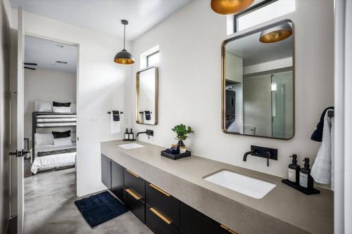 a bathroom with two sinks and a large mirror at NEW Modern 3BR & Loft- Heated pool, Near airport in Phoenix