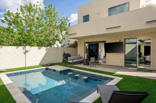 a swimming pool in the backyard of a house at NEW Modern 3BR & Loft- Heated pool, Near airport in Phoenix
