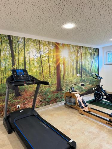 a room with a wall mural of a forest at Hotel Garni Villa Toskana in Parsberg