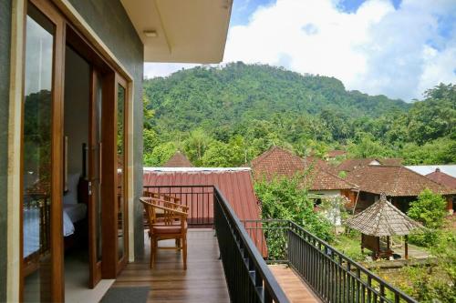 a balcony of a house with a view of the mountains at Gria Sindhu Homestay Sidemen by AGATA in Sidemen