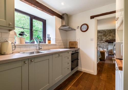 a kitchen with a sink and a counter top at Bwthyn Gwyn in Llanerchymedd
