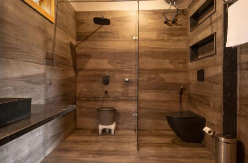 a bathroom with a glass shower stall with a toilet at The Destin Ekaant By 3Tree Group in Belparāo